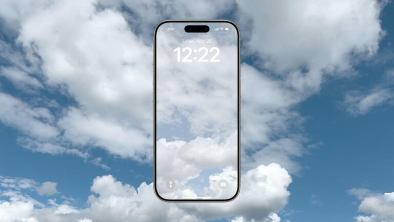 An iPhone with a cloud image wallpaper floating in front of a sky full of clouds.